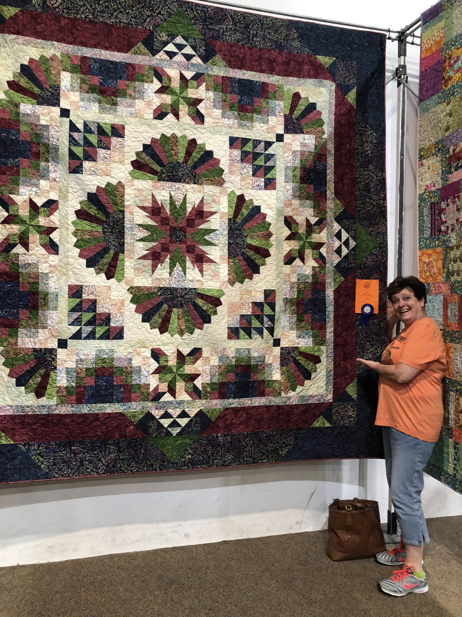 Mary Ellen with award-winning quilt at show